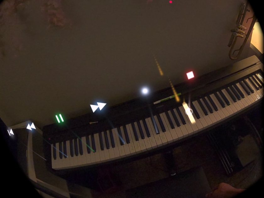Headset view of the piano with note cues and playback controls floating above the keys